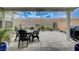 Inviting outdoor dining area with a large table and chairs set on a paver patio and beautiful landscaping at 2651 Deep Canyon St, Henderson, NV 89044