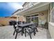 Charming covered patio with dining, lounge furniture, and lush landscaping at 2651 Deep Canyon St, Henderson, NV 89044