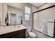 Modern bathroom featuring a dark vanity, a large mirror, and a glass-enclosed shower with white tile at 2651 Deep Canyon St, Henderson, NV 89044
