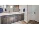 Bathroom featuring a double sink vanity with grey cabinets and gold hardware at 2651 Deep Canyon St, Henderson, NV 89044