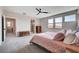 Bedroom featuring a luxurious gray carpet, natural lighting, and adjacent bathroom at 2651 Deep Canyon St, Henderson, NV 89044