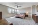 Spacious bedroom with a ceiling fan, multiple windows, and light gray carpet flooring at 2651 Deep Canyon St, Henderson, NV 89044