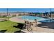 Community pool featuring poolside seating, shade structures, and well-maintained green space at 2651 Deep Canyon St, Henderson, NV 89044