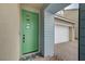Welcoming entryway with a modern green door, brick pathway, and landscaped garden, enhancing curb appeal at 2651 Deep Canyon St, Henderson, NV 89044