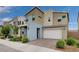 Contemporary two-story home featuring a spacious garage, brick driveway, and attractive landscaping at 2651 Deep Canyon St, Henderson, NV 89044