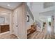 Elegant foyer featuring wood-look flooring, a staircase, and a view into the open-concept living area at 2651 Deep Canyon St, Henderson, NV 89044
