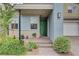Inviting front porch with a modern green door, brick pathway, and lush greenery, creating a welcoming entrance at 2651 Deep Canyon St, Henderson, NV 89044
