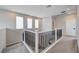 Upstairs hallway featuring neutral colored walls, plush carpet, and modern railings at 2651 Deep Canyon St, Henderson, NV 89044