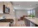 Kitchen with stainless steel appliances, a view of the dining area, and plenty of natural light at 2651 Deep Canyon St, Henderson, NV 89044