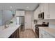 Well-lit kitchen with stainless appliances, quartz countertops and a large island, perfect for cooking at 2651 Deep Canyon St, Henderson, NV 89044