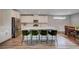 Modern kitchen featuring stainless steel appliances, a large center island with seating, and an open dining area at 2651 Deep Canyon St, Henderson, NV 89044