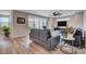 Cozy living room with wood-look floors, a sectional sofa, and sliding doors leading to an outdoor space at 2651 Deep Canyon St, Henderson, NV 89044
