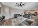 Open-concept living room with hardwood floors, comfortable seating, and a view to the kitchen at 2651 Deep Canyon St, Henderson, NV 89044