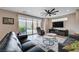 Bright living room with hardwood floors, stylish furniture, and sliding glass doors to the outdoor patio at 2651 Deep Canyon St, Henderson, NV 89044