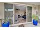 View from a covered patio to a cozy living room with modern furniture through sliding glass doors at 2651 Deep Canyon St, Henderson, NV 89044