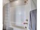 The bath has a new shower with white subway tile and a bronze shower head at 2651 Deep Canyon St, Henderson, NV 89044