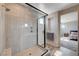 Modern glass-enclosed shower with vertical light tile and silver hardware at 2651 Deep Canyon St, Henderson, NV 89044