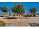 A tree-lined walking path is landscaped with small bushes and desert rock at 2651 Deep Canyon St, Henderson, NV 89044