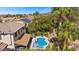 Aerial view of backyard oasis featuring a pool, lush landscaping, and a relaxing spa area at 2717 Cool Lilac Ave, Henderson, NV 89052