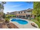 Expansive backyard featuring a sparkling pool, patio, lush greenery, and inviting outdoor seating areas at 2717 Cool Lilac Ave, Henderson, NV 89052
