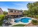 A spacious backyard oasis with a pool, patio, and beautifully landscaped areas for outdoor entertaining at 2717 Cool Lilac Ave, Henderson, NV 89052
