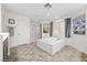 Bathroom with a large soaking tub, walk-in shower, and neutral tile flooring at 2717 Cool Lilac Ave, Henderson, NV 89052