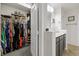 Walk-in closet adjacent to bathroom featuring vanity with sink and mirror at 2717 Cool Lilac Ave, Henderson, NV 89052