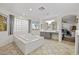 Bright bathroom featuring a large soaking tub, gray vanity, and natural light at 2717 Cool Lilac Ave, Henderson, NV 89052