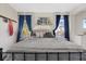 Bedroom featuring a queen bed, dark blue curtains, natural lighting and neutral colors at 2717 Cool Lilac Ave, Henderson, NV 89052