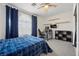 Comfortable bedroom with a large window, dark curtains, and a ceiling fan at 2717 Cool Lilac Ave, Henderson, NV 89052