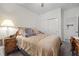 Comfortable bedroom featuring a queen bed with a stylish lamp on a wooden nightstand at 2717 Cool Lilac Ave, Henderson, NV 89052