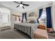 Bedroom with a queen bed, dark blue curtains and natural lighting at 2717 Cool Lilac Ave, Henderson, NV 89052