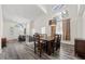 Open-concept dining area with a modern chandelier and wood floors, seamlessly connects to the living room at 2717 Cool Lilac Ave, Henderson, NV 89052