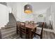 Elegant dining room features a stylish chandelier, wood floors, and staircase to the second level at 2717 Cool Lilac Ave, Henderson, NV 89052