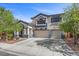 Charming two-story home with a landscaped front yard and a spacious driveway leading to a two-car garage at 2717 Cool Lilac Ave, Henderson, NV 89052