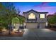 Inviting two-story home with a well-manicured lawn, complemented by a wide driveway leading to a two-car garage at 2717 Cool Lilac Ave, Henderson, NV 89052