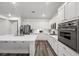 Bright and airy kitchen with white cabinets, stainless steel appliances, and center island with sink at 2717 Cool Lilac Ave, Henderson, NV 89052