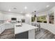 Bright kitchen features a large island, white cabinets, stainless appliances, and breakfast nook at 2717 Cool Lilac Ave, Henderson, NV 89052