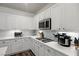 Modern kitchen features white cabinets, subway tile backsplash and stainless steel appliances at 2717 Cool Lilac Ave, Henderson, NV 89052