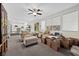 Open living room featuring neutral furniture, large windows, and backyard view at 2717 Cool Lilac Ave, Henderson, NV 89052