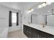 Bathroom with a double sink vanity, a large mirror, and modern fixtures at 311 Lilian Faith Ave, North Las Vegas, NV 89031