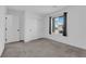 Bedroom with neutral walls and carpet, featuring a window with blinds and curtains at 311 Lilian Faith Ave, North Las Vegas, NV 89031