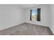 A well-lit bedroom features a window and soft carpeting at 311 Lilian Faith Ave, North Las Vegas, NV 89031