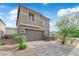 Beautiful front exterior featuring a two-car garage, attractive landscaping, and a contemporary design under a bright sky at 311 Lilian Faith Ave, North Las Vegas, NV 89031