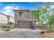 Charming two-story home featuring a well-manicured yard and a two-car garage on a beautiful, sunny day at 311 Lilian Faith Ave, North Las Vegas, NV 89031