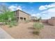 Expansive front yard with desert landscaping, a gated entrance, and a contemporary home design on a sunny day at 311 Lilian Faith Ave, North Las Vegas, NV 89031