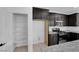 View of kitchen and open pantry space, featuring stainless steel appliances and granite countertops at 311 Lilian Faith Ave, North Las Vegas, NV 89031