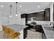 Modern kitchen with stainless steel appliances, granite countertops, island and dark cabinetry at 311 Lilian Faith Ave, North Las Vegas, NV 89031