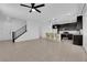 Open-concept living area with sleek tile floors, modern pendant lighting, and a staircase leading to the second floor at 311 Lilian Faith Ave, North Las Vegas, NV 89031