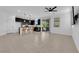 Spacious living room featuring tile flooring, modern lighting, and a seamless transition to the outdoor patio at 311 Lilian Faith Ave, North Las Vegas, NV 89031